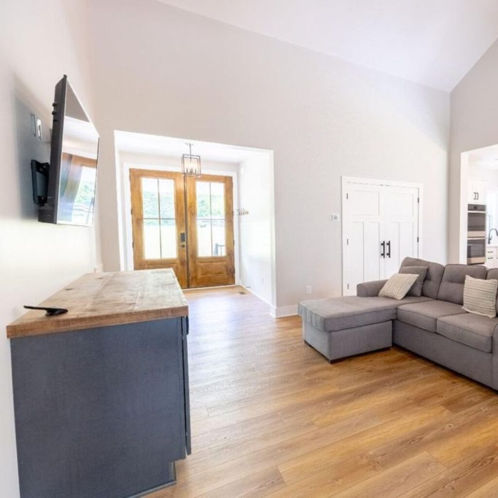 an open living room with a couch and tv