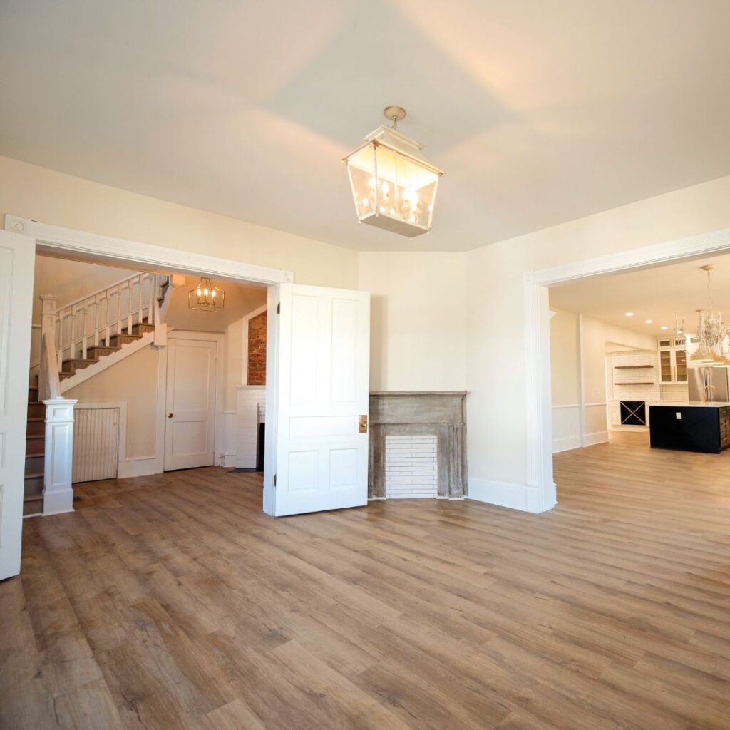 an open floor connecting a living room to the stairs