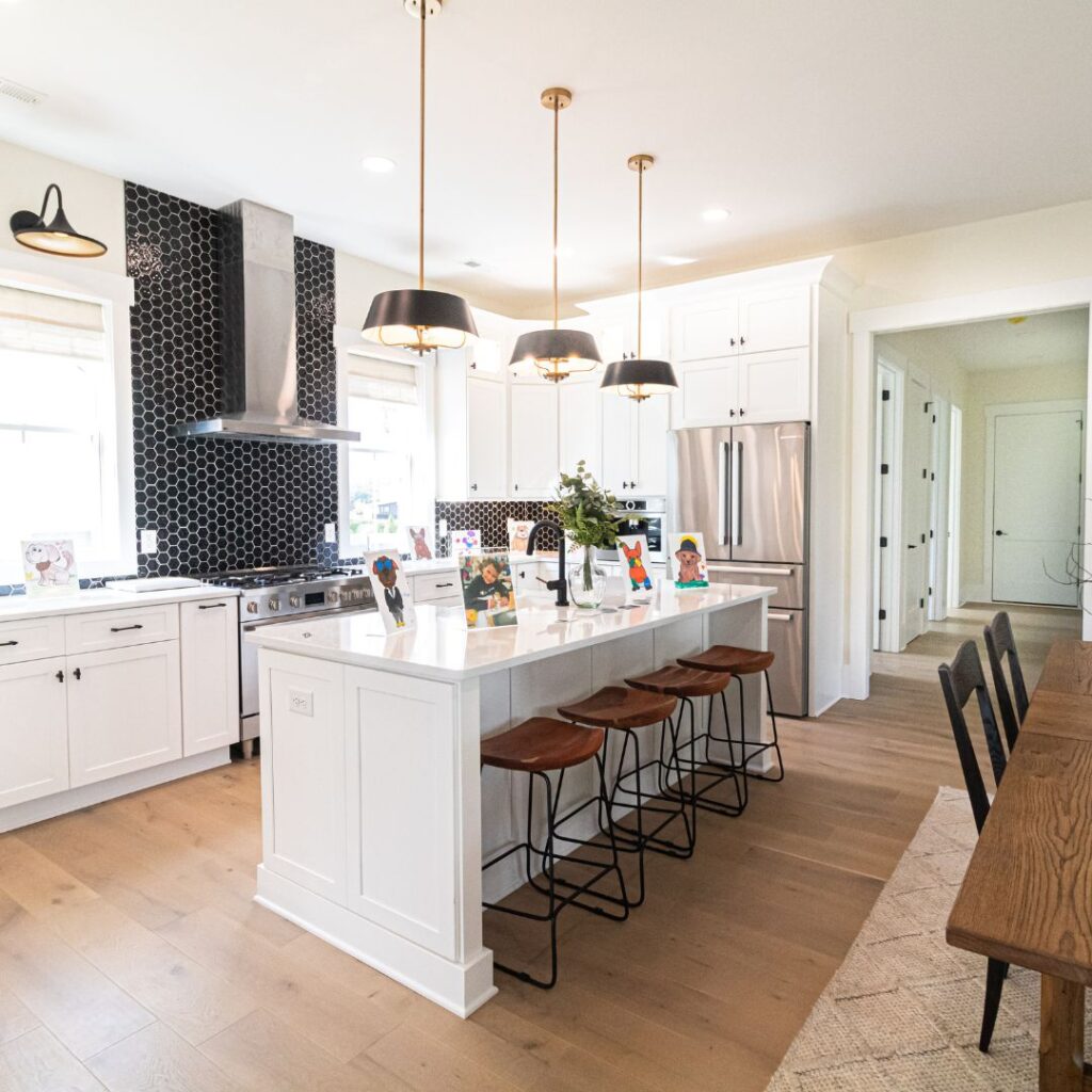 kitchen with hardwood floors, and island and black accent tiled wall behind the stove